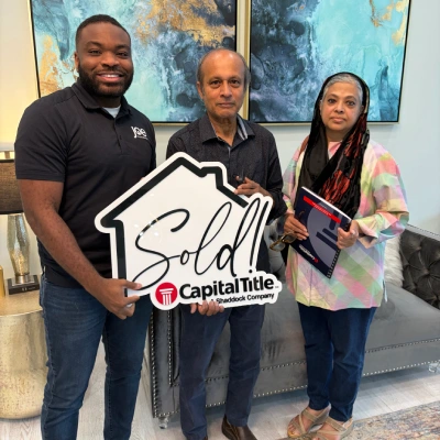 Happy Sellers With Sold Sign